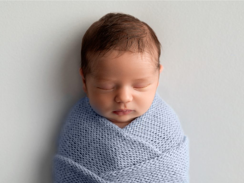 Baby boy in pastel wrap newborn photographer